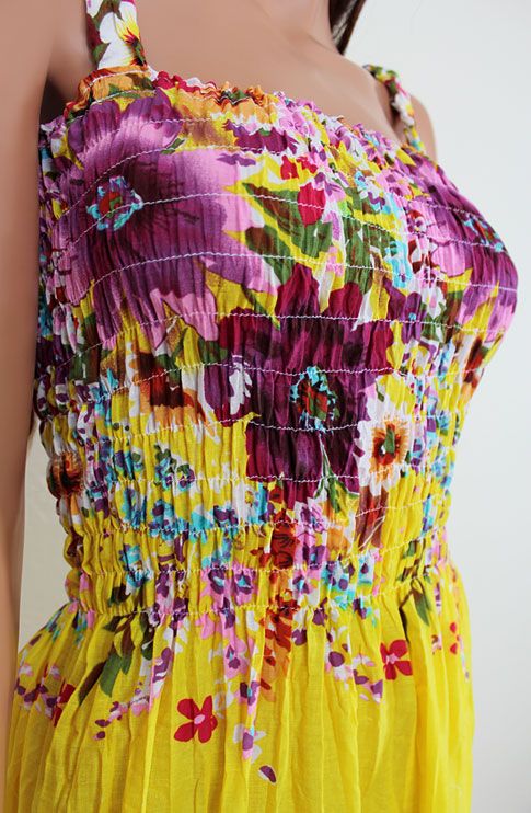 Colorful maxi sundress that features smocked bust line, elastic 